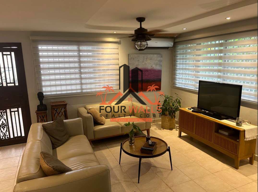 Kitchen with dark wood cabinets, granite countertops, stainless appliances at Condado del Rey house Panama