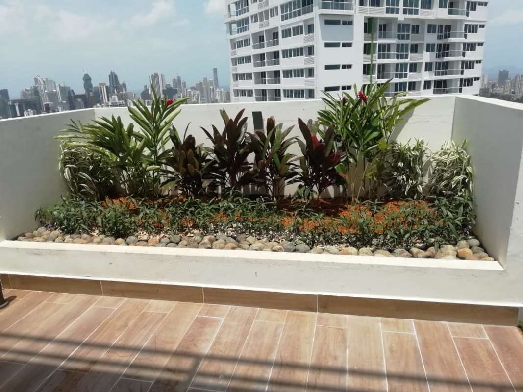 Balcony with raised garden bed overlooking skyline at PH Panoramic Tower Edison Park