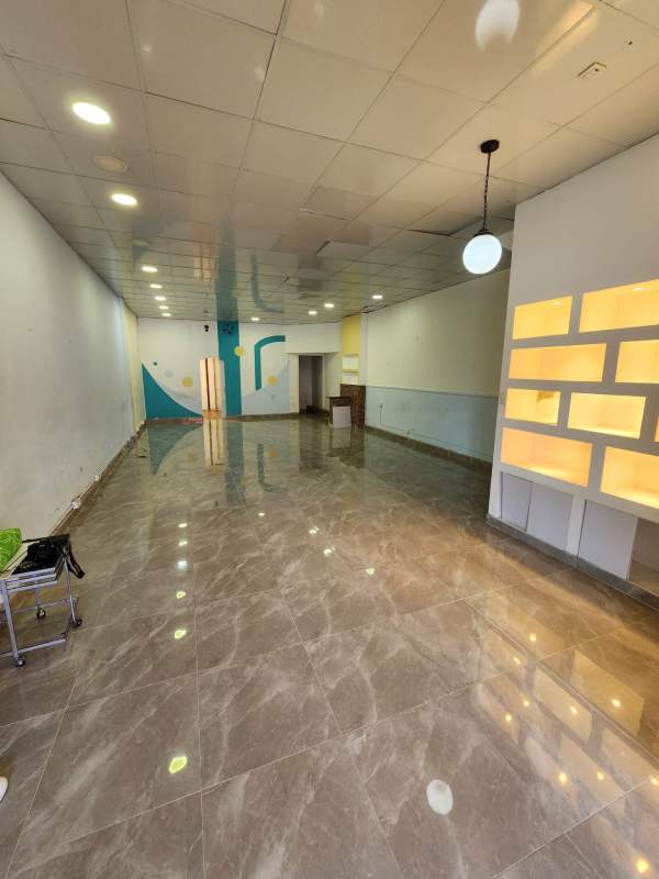 Interior empty commercial retail space with tiled floor, accent wall, open layout Brisas Commercial Plaza Panama
