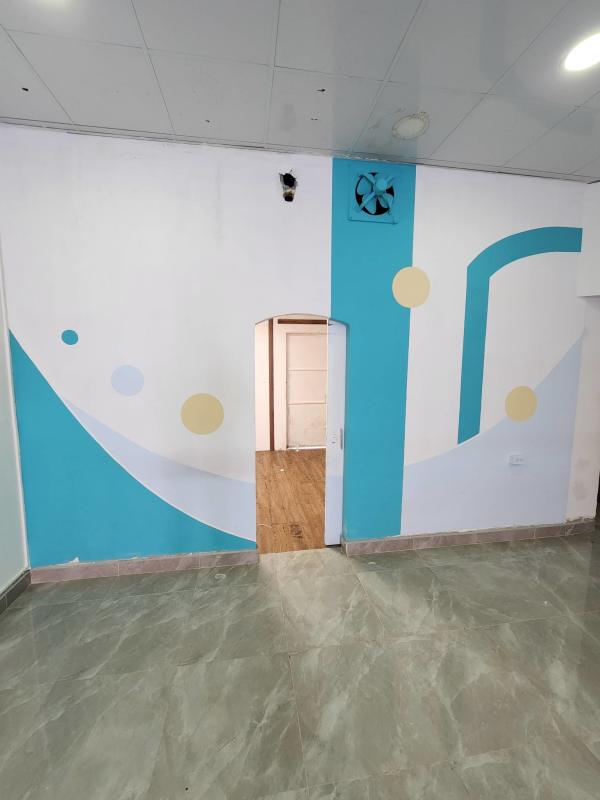 Interior retail space with colorful accent wall, tiled flooring, ceiling lighting Brisas del Golf Panama