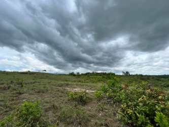 Wide open agricultural plain with cloudy sky ideal for farming near Antón