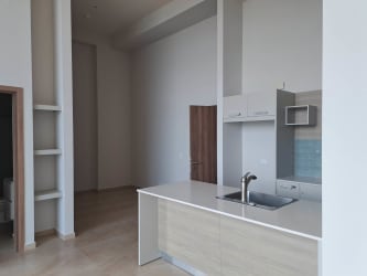 Open plan living and dining area with floor-to-ceiling windows in Royal Palm Playa Gorgona condo