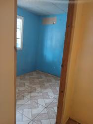 Simple kitchen with ceramic tile counters and backsplash in affordable rental Arraiján Panama