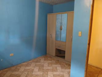 Simple bedroom blue walls ceramic tile mirror wardrobe affordable apartment Arraiján Panama
