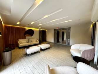 Spacious living area with large window, balcony access, and split AC in PH Madeira Panama