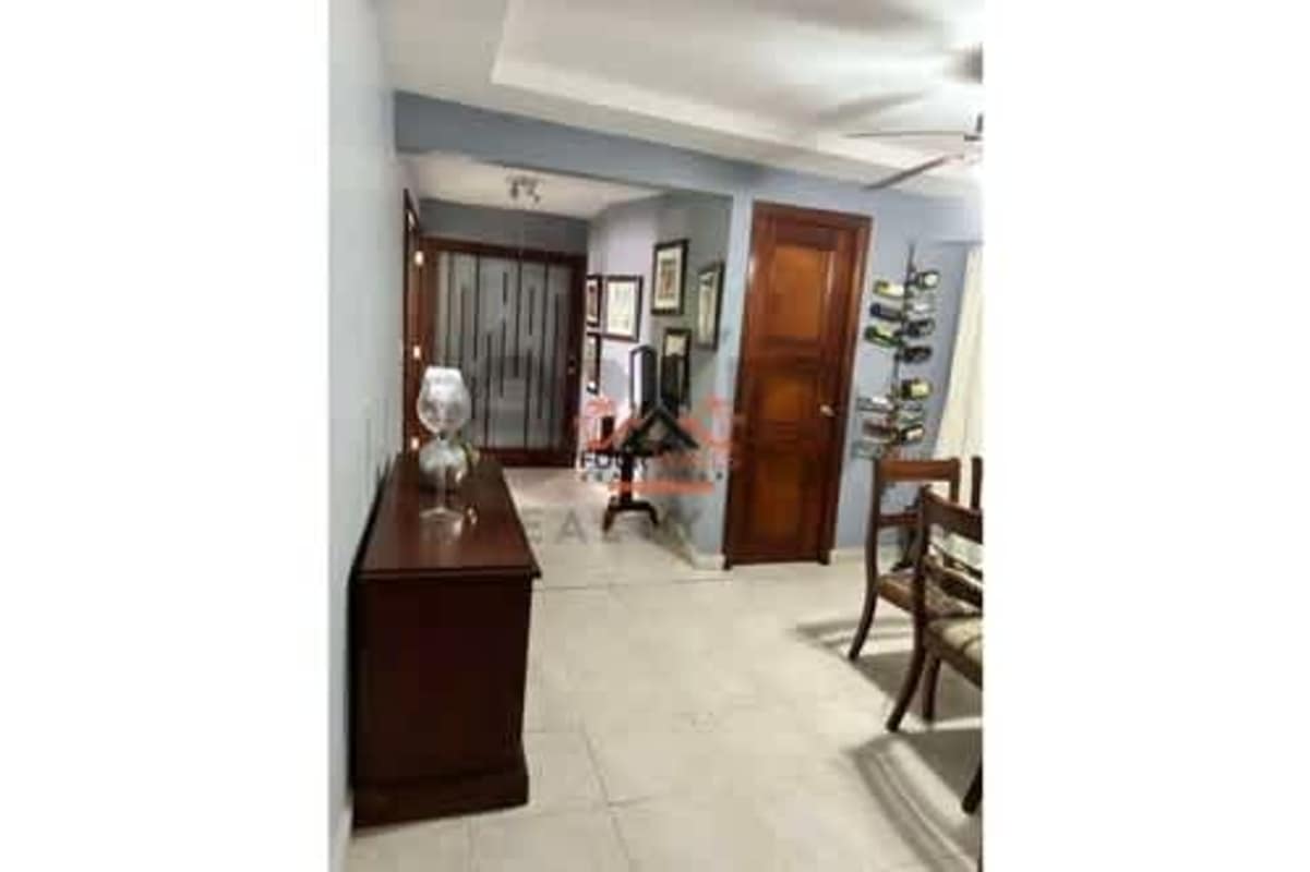Kitchen with wood cabinetry, tile countertops, appliances in Condado del Rey Panama house