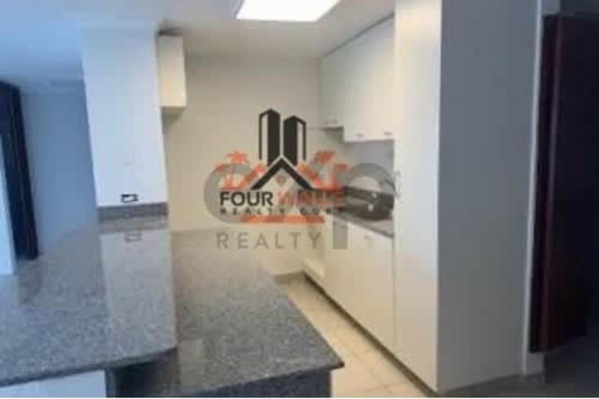 Minimalist modern kitchen with granite breakfast bar in PH Central Park Panama