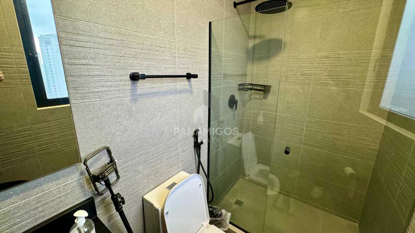Designer bathroom with walk-in shower, black fixtures in Coco del Mar Panama