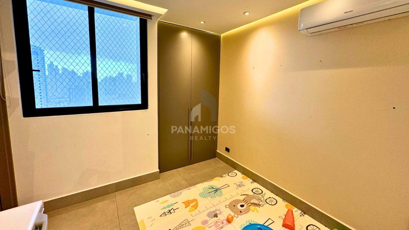 Secondary bedroom with city view window and modern built-in wardrobe in Coco del Mar