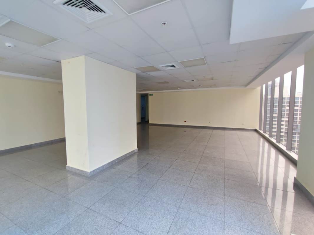 Interior empty office with large windows, suspended ceiling, tiled floors in Torre SFC Panama City