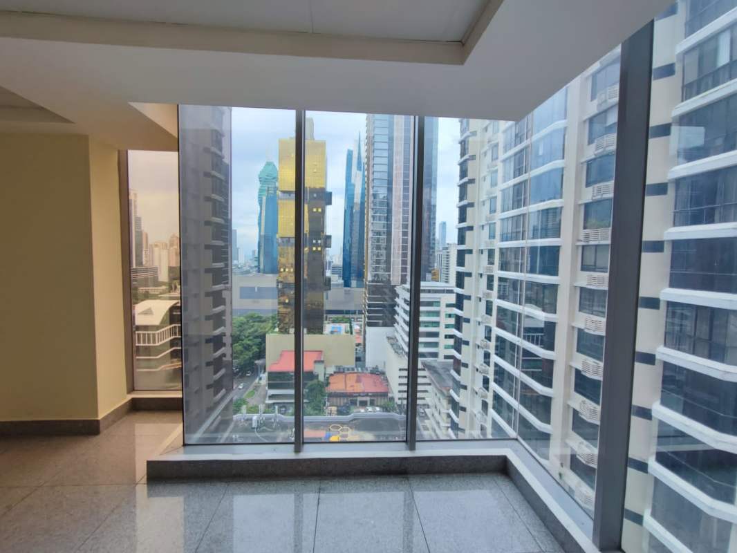 Interior corridor or lobby area with large glass windows showcasing city skyline at Torre SFC Panama