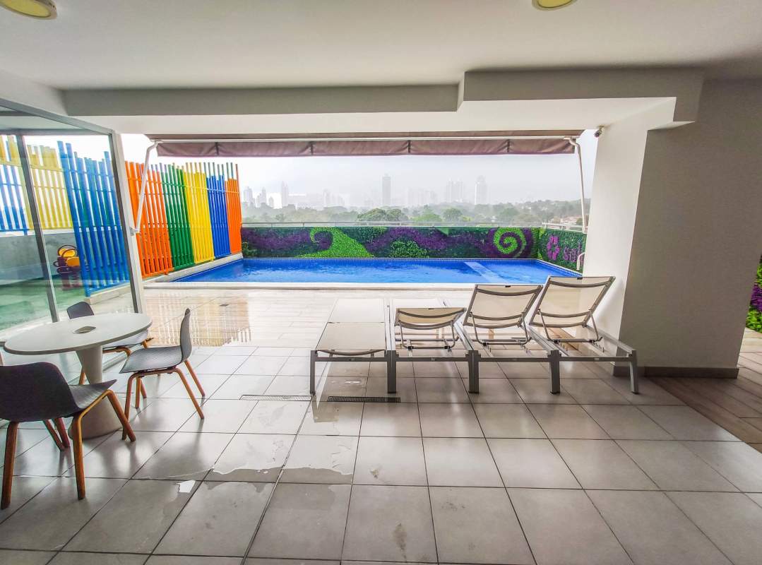 Open plan living dining area with balcony access and city view at PH Solok Parque Lefevre Panama City
