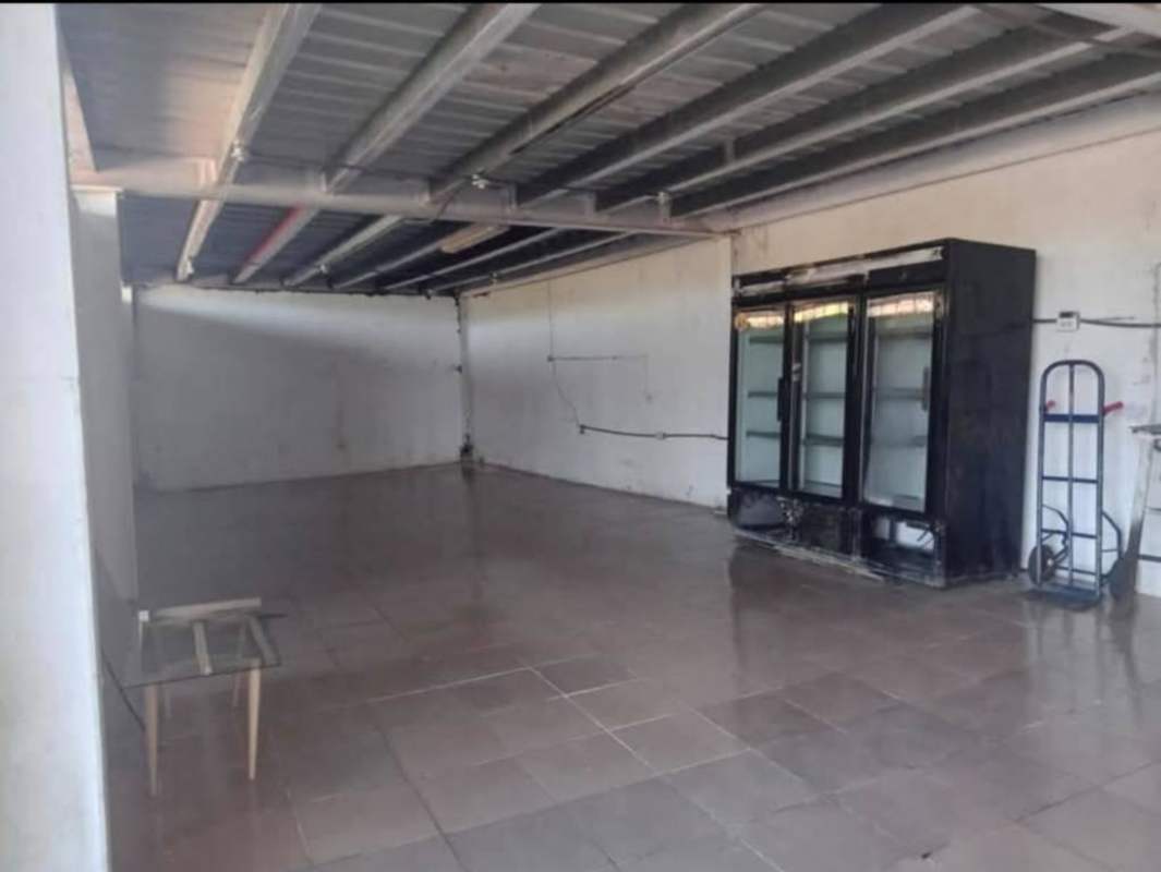 Commercial interior tiled floor, exposed ceiling, refrigeration with minimal furnishings Samaria Panama