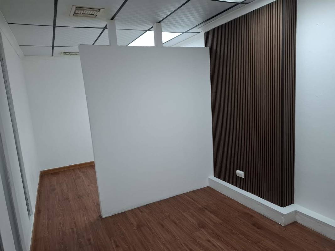 Office room with large window, tile floors and city skyline view in Villa de las Fuentes Panama