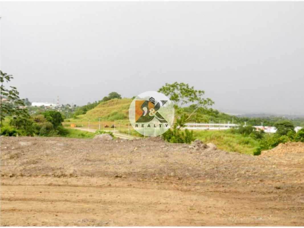 Cleared hillside lot with dirt surface and distant suburban view, Brisas del Golf Panama