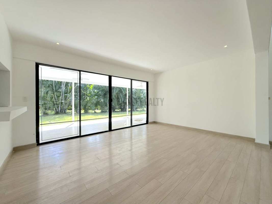 Spacious bedroom with window overlooking garden in Cardenas Clayton Panama