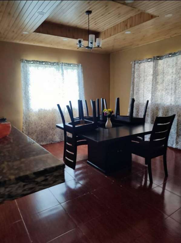 Bathroom with blue and white tiles, glass shower door in house Pedregal Panama