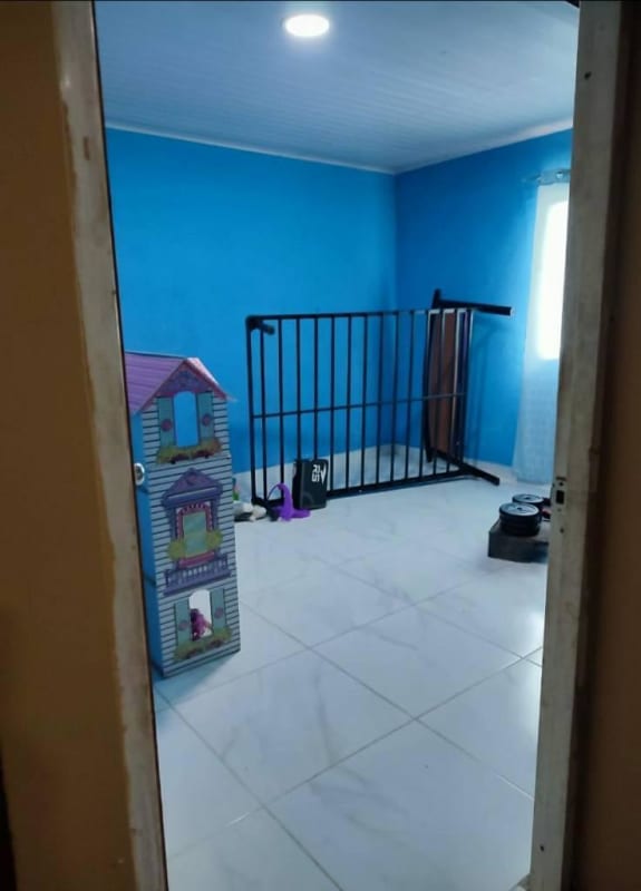 Child's room with blue walls, white tile and toys in Santa Cruz Panama