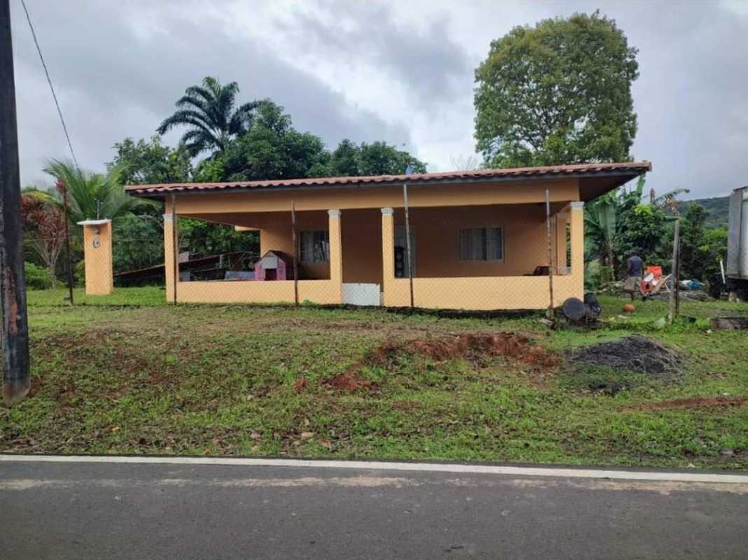 Yellow detached house with covered front porch surrounded by garden in Santa Cruz Pedregal Panama