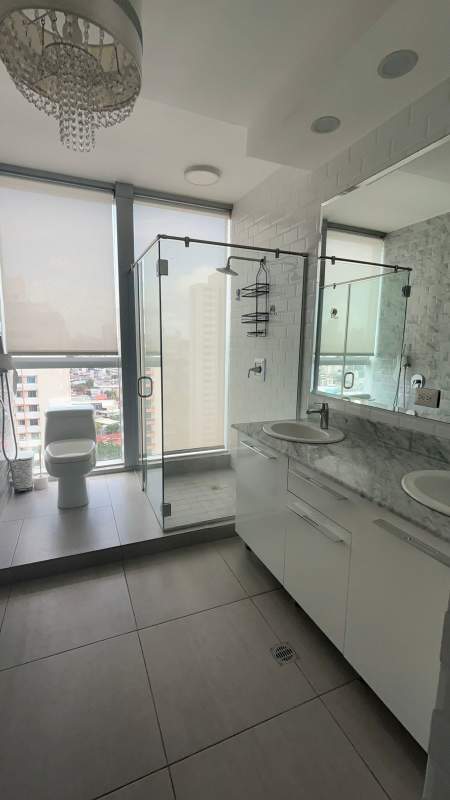 Modern bathroom with glass-enclosed shower, granite vanity in PH Jade Tower San Francisco Panama