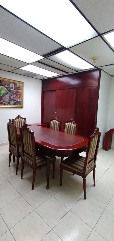 Conference room with wooden table and upholstered chairs in Plaza 2000 tower commercial office Panama