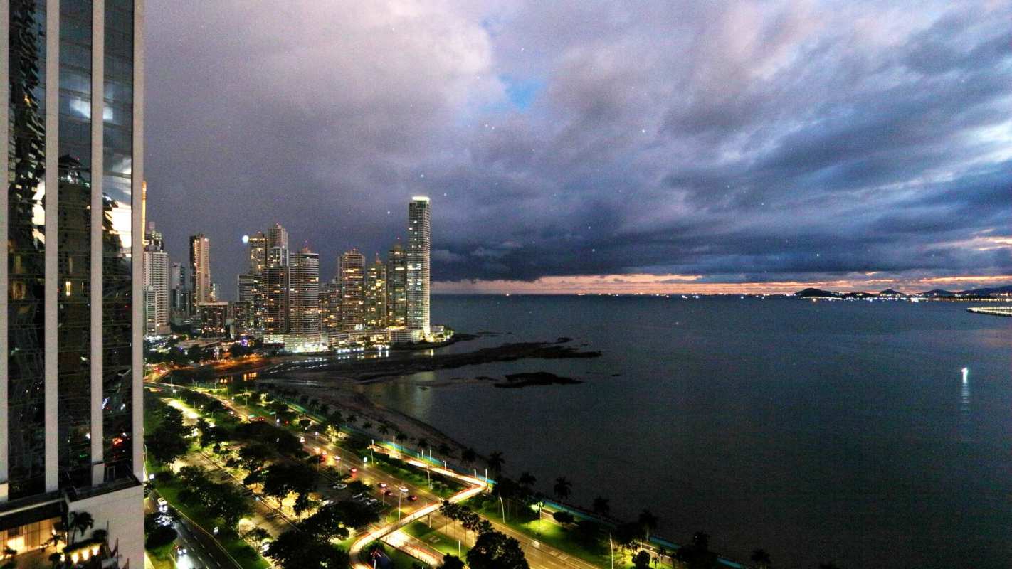 Balcony with city skyline and ocean sunset at PH Yoo Panama on Avenida Balboa
