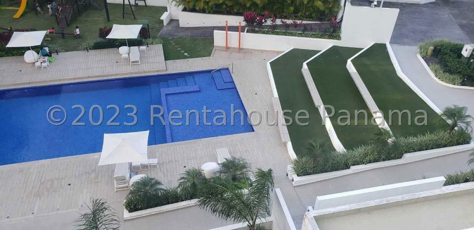Outdoor swimming pool area with playground PH Garden City Clayton Panama apartment amenities