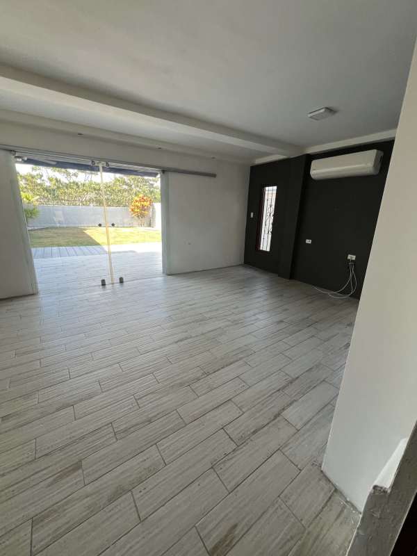 Bright spacious kitchen with cabinets, countertops and window Green Village Panama