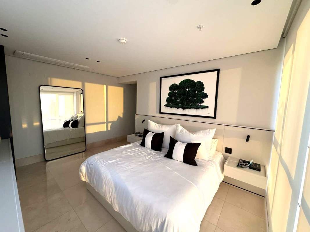 Minimalist bedroom with floor-to-ceiling windows ocean view PH Wind Rose Panama City