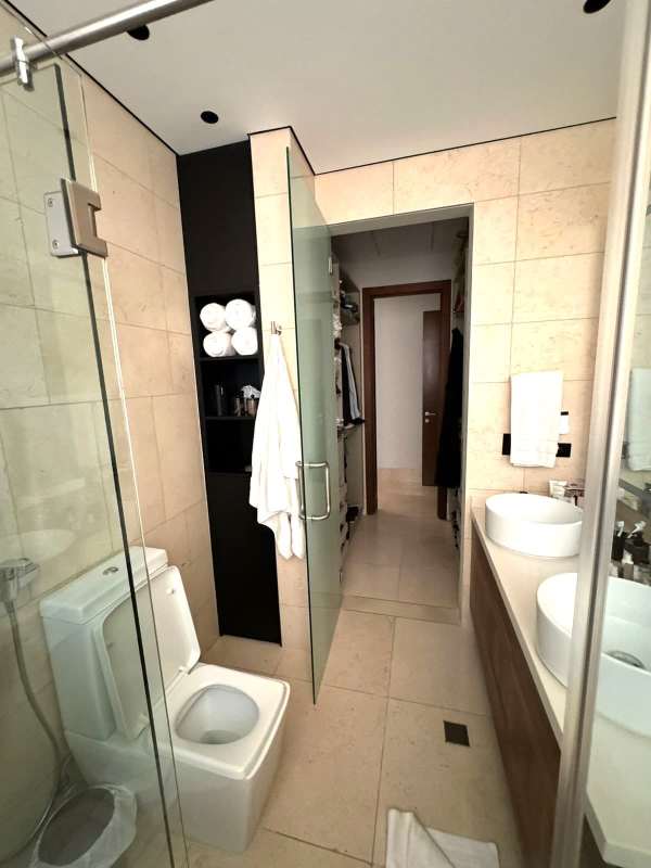 Ensuite bathroom with double sinks glass shower connecting walk-in closet PH Wind Rose Panama