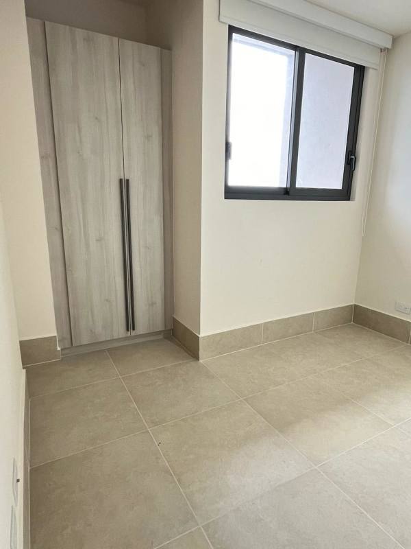 Bright secondary bedroom with large window and closet at Ocean House Santa Maria Panama