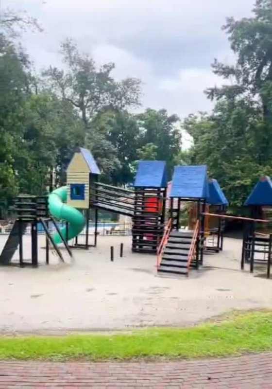 Family-friendly children's playground with slides swings at Senderos Camino de Cruces gated community Clayton