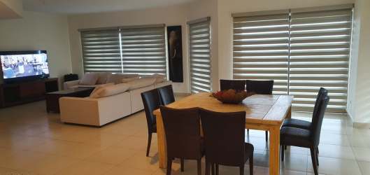 Luxury coastal condo open-plan area with large windows and balcony