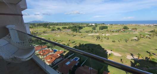 Large balcony terrace with hammock, ocean, and golf course views