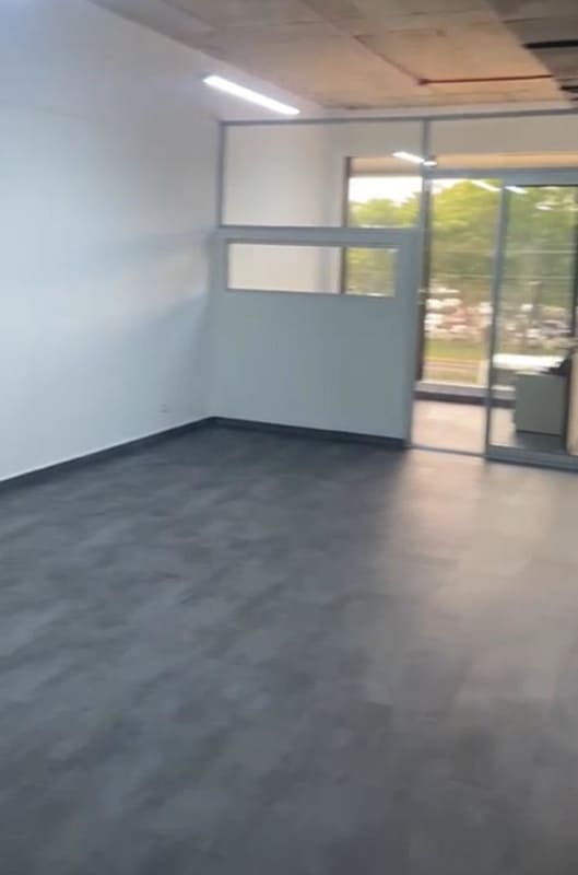 Empty office with white walls and dark tiles space for cubicles PH BICSA Marbella Panama