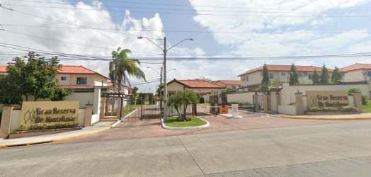 Gran Reserva de Montelimar gated entrance with palm trees and signage Panama
