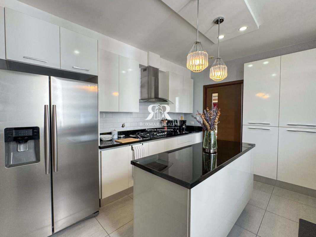 Modern kitchen white cabinets black granite island stainless appliances PH Jade Tower San Francisco Panama City