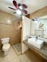 Open bright living dining area with tiled floors large windows in Costa Verde house