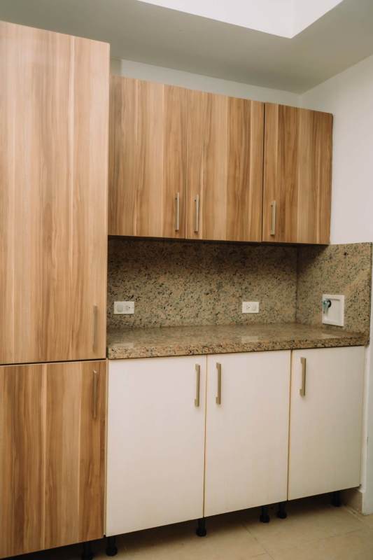 Bright spacious living room with large windows and tiled floors Embassy Village apartment Panama