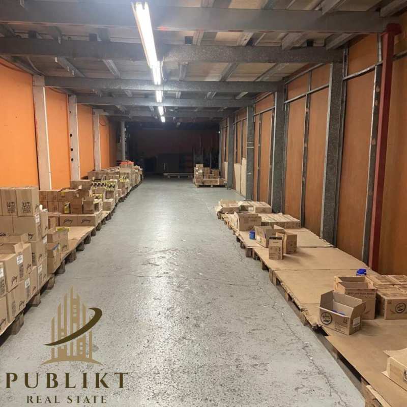 Interior warehouse with wood pallets and orange walls in Panama City's Rio Abajo industrial area