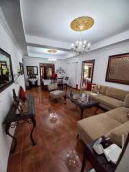 Spacious traditional living and dining room with chandeliers, tiled floors in Penonomé Panama