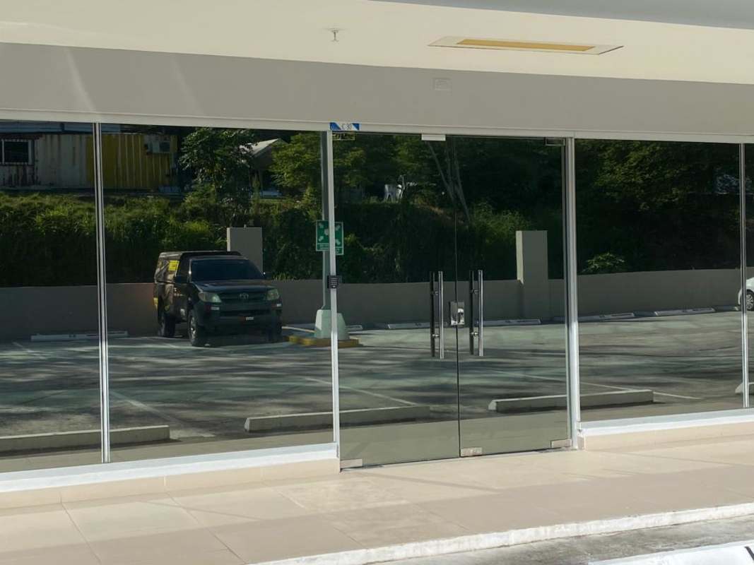 Minimalist interior commercial unit with tile floor exposed ceiling Terrazas de Albrook Panama