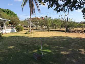 Exterior view of house with covered carport, fenced boundary and partial garden in Penonomé property