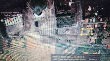 Aerial view marked plot near Penonomé baseball stadium with road access and greenery