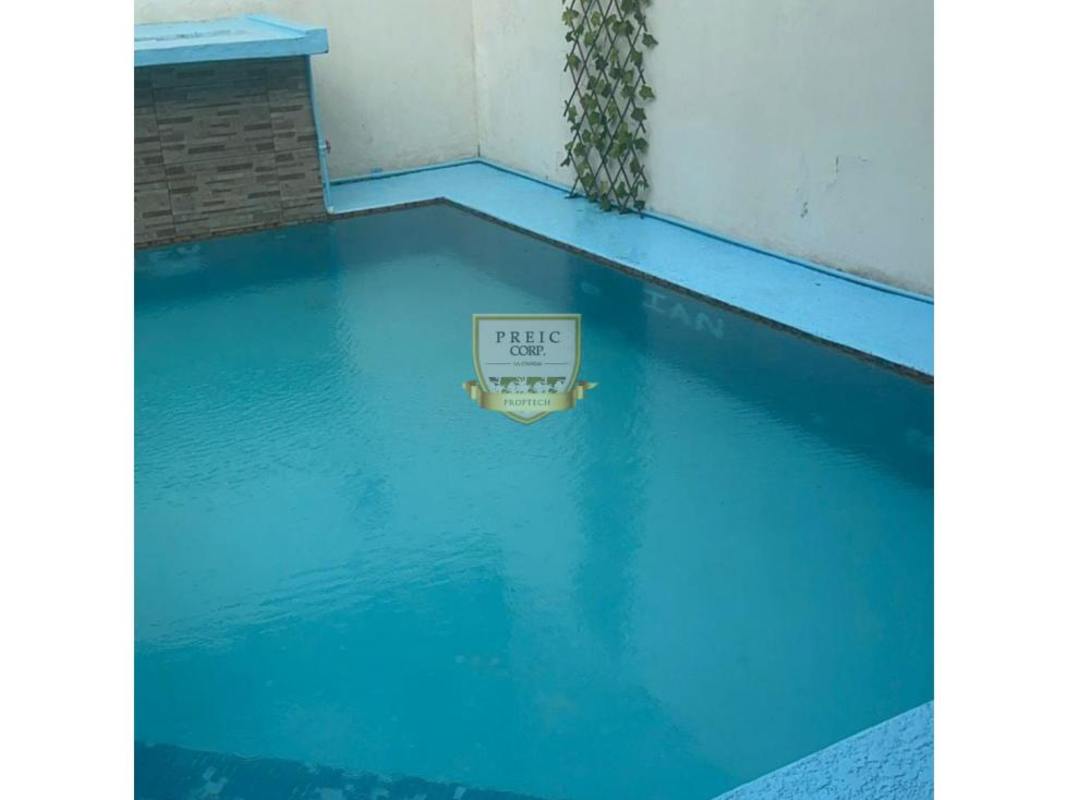 Small private swimming pool with decorative wall and green trellis in Brisas del Golf house Panama