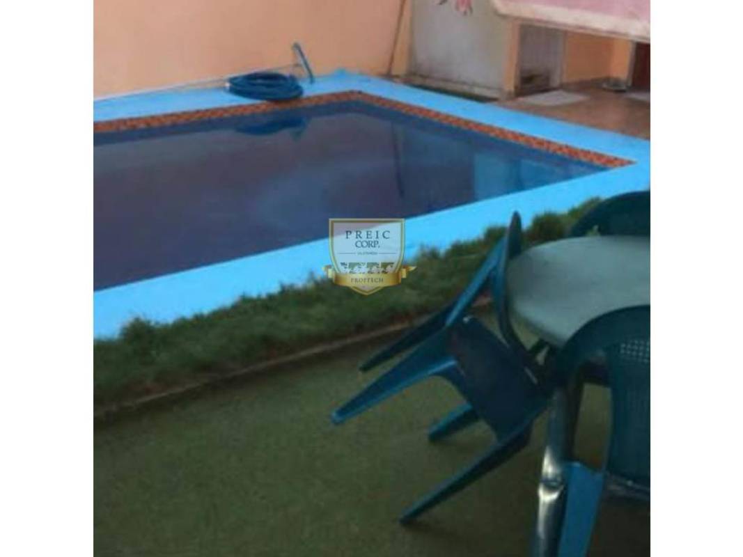 Front entrance with two-car carport and security gates in Brisas del Golf Panama house for sale