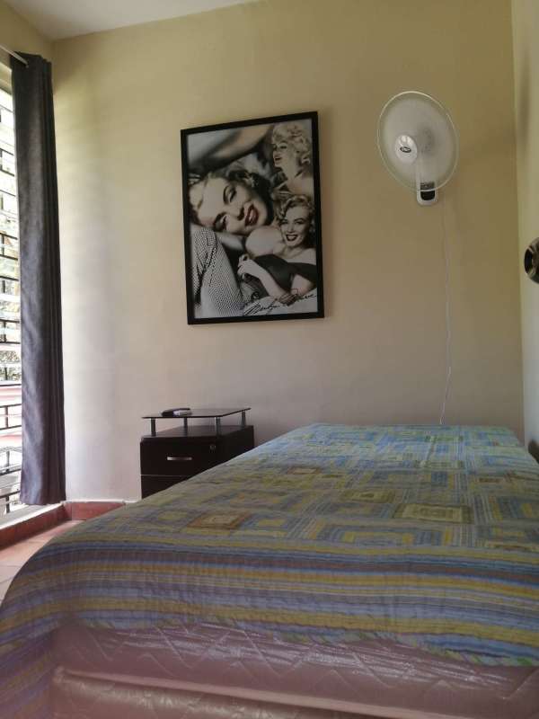 Large covered balcony with awning overlooking tropical garden in El Carmen, perfect for gatherings