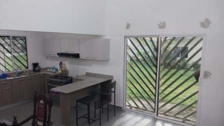 Open kitchen with breakfast bar sliding doors garden access La Reserva Santiago Panama