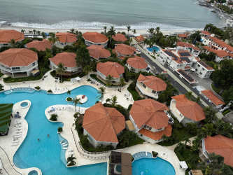 Aerial Mediterranean style beachfront complex with pools and villas at Coronado Panama