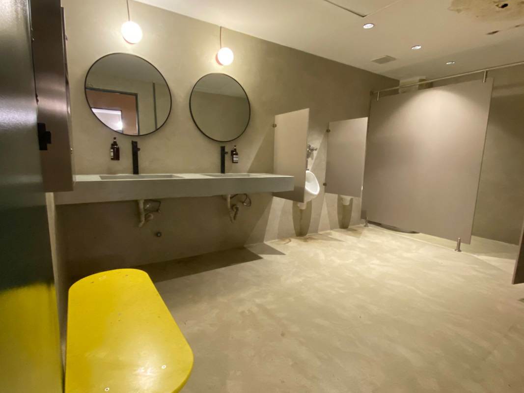 Commercial public restroom with sinks mirror partitions in Edificio Heurtematte Casco Viejo